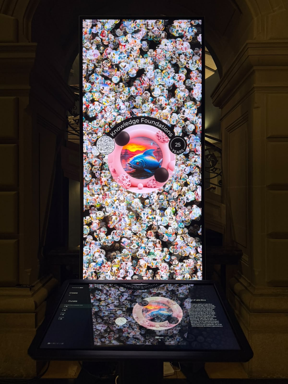 Vertical totem screen displaying the Knowledge Foundations vision of the Koi of Lake Biwa, installed in a stone archway.